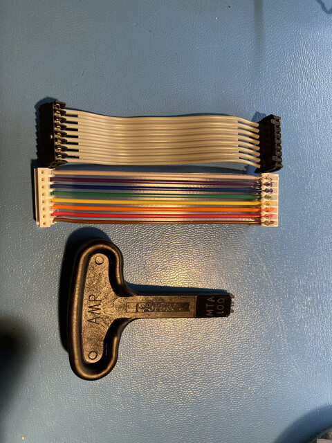 An old cable, a new one and the tool for assembling the connectors.